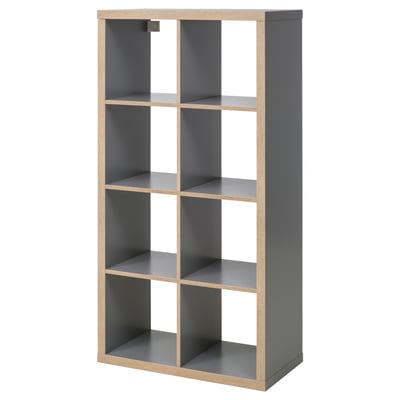 Displays an empty gray KALLAX shelf unit with multiple compartments, featuring a modern and minimalist design.