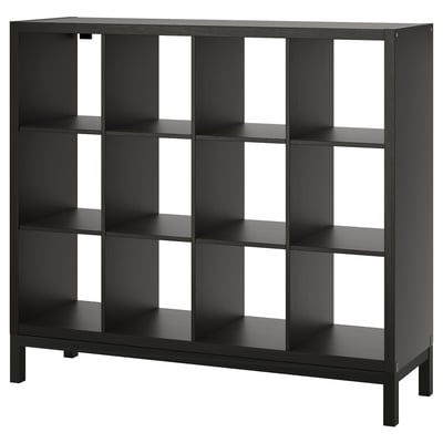 A black KALLAX shelf unit with multiple cubes for storage, showcasing a modern, minimalist design with square compartments and an airy underframe.