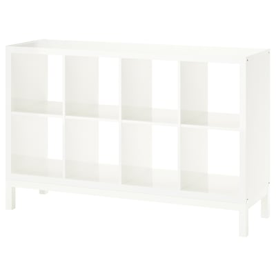 A white KALLAX shelving unit with multiple open cubes, supported by an underframe for an airy look, ideal for storage and display.