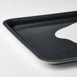 Black rectangular tray with curved edges, made of high-pressure melamine laminate. Suitable for carrying items and doubling as wall decor.