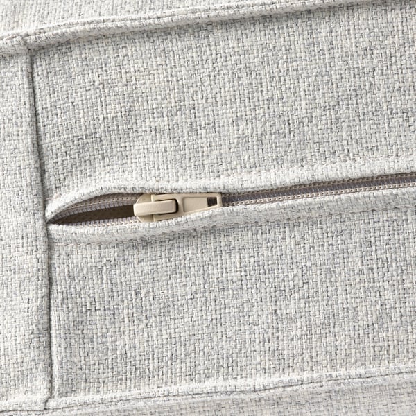 Close-up of textured, grey sofa pocket with zip, showcasing quality fabric and durable design.
