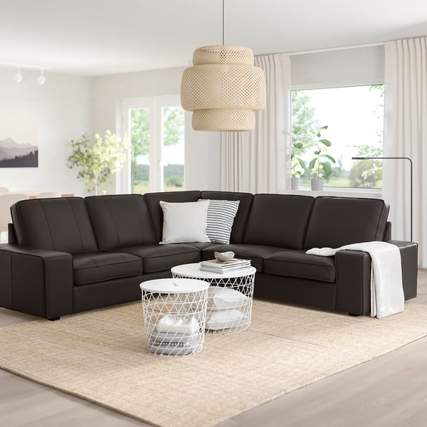 Black KIVIK sofa, light, tables, lamp, bright living room.