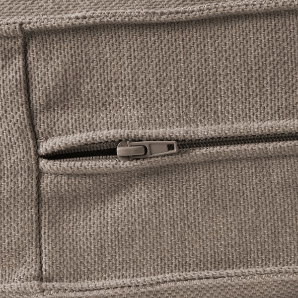 Close-up of durable, soft-textured fabric zipper on a cushioned sofa.