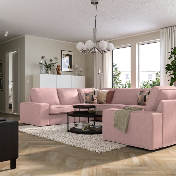 Modern living room with large light pink KIVIK sectional sofa, big windows, cozy.