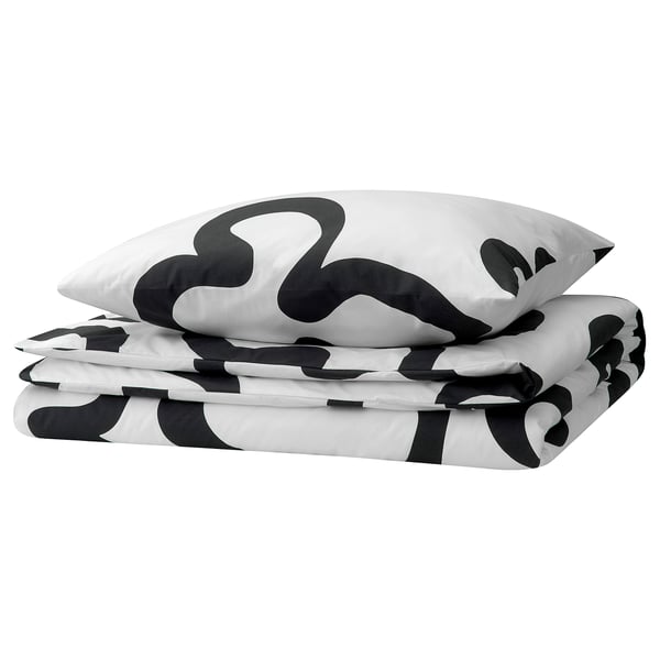Black and white patterned duvet cover and pillowcases, folded, with abstract shapes.