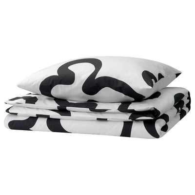 Black and white patterned duvet cover and pillowcases, folded, with abstract shapes.