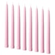 Nine pale pink KLOKHET candles in a row, cylindrical shape, made of stearin.