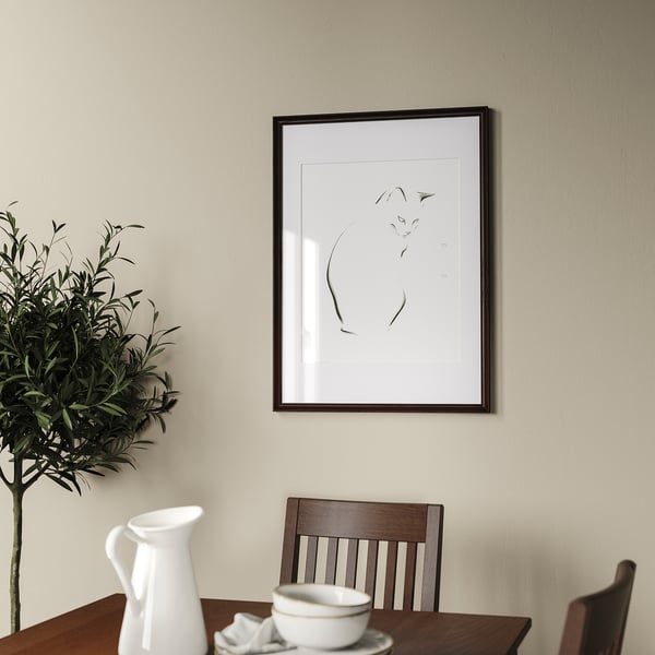 Minimalist dining room with art print, table, and decorative jug.