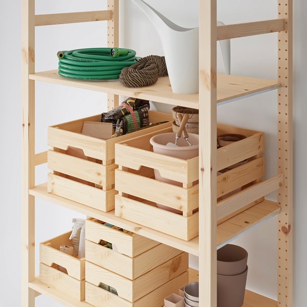 Wooden KNAGGLIG storage box with tools, hose, pots, and vases; light brown, medium size, rectangular, with handles.