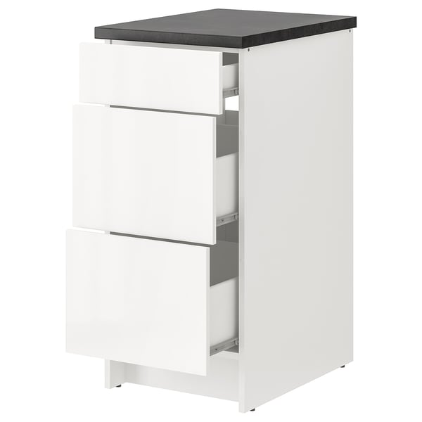 White KNOXHULT modular kitchen cabinet with three drawers and dark grey countertop.