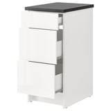 White KNOXHULT modular kitchen cabinet with three drawers and dark grey countertop.