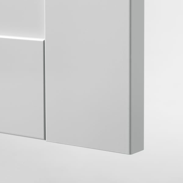 Modern kitchen cabinet close-up, smooth white finish, clean edges.