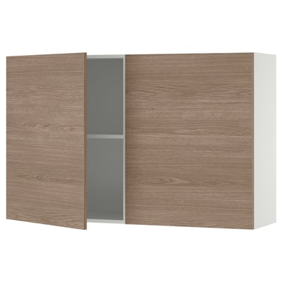 KNOXHULT wall cabinet in light brown wood. Two doors, one ajar revealing a grey interior and shelf. Modern and minimalist design.