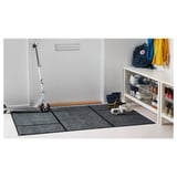 Entryway scene with white scooter, shoe rack, and KÖGE mat.