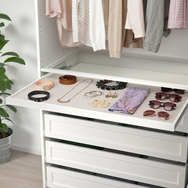 White dresser with felt mat displaying accessories in open drawer. Mat prevents sliding.