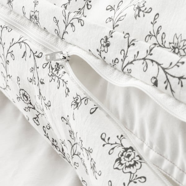 White duvet cover with floral print and zipper closure, featuring soft cotton and viscose blend for temperature regulation and comfort.