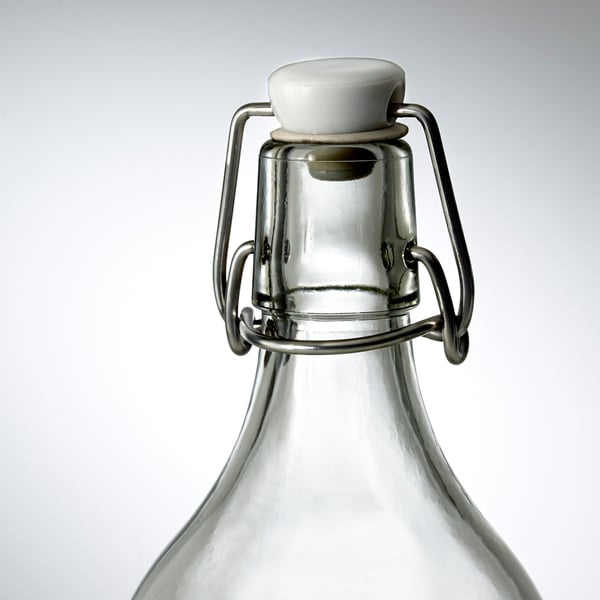 Glass bottle with sturdy metal clasp and tight seal ensuring freshness.