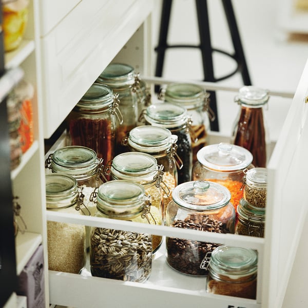 Jars in cabinet, storing food for freshness, sealed for flavor preservation.