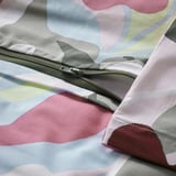 Close-up of a colorful, patterned duvet with a zipper closure, showcasing its silky-soft cotton-viscose blend.