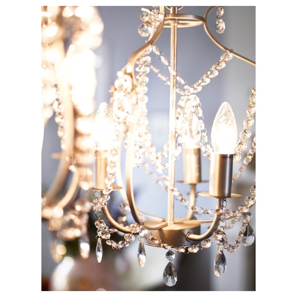 Elegant chandelier with sparkling crystals spreads soft light. Adjustable height, uses e14 bulbs.