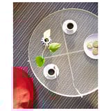 KROKHOLMEN mesh coffee table, beige, circular, metal, with coffee cups and cookies.