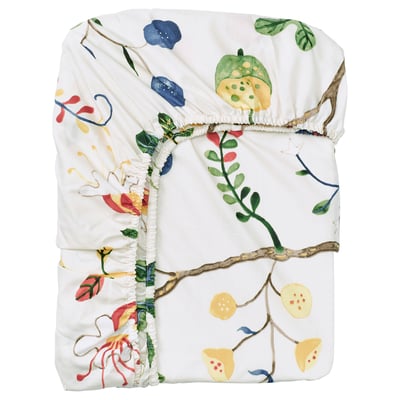 The KRONBUSKE blanket a white base with colourful floral prints, made from 57% cotton and 43% lyocell.