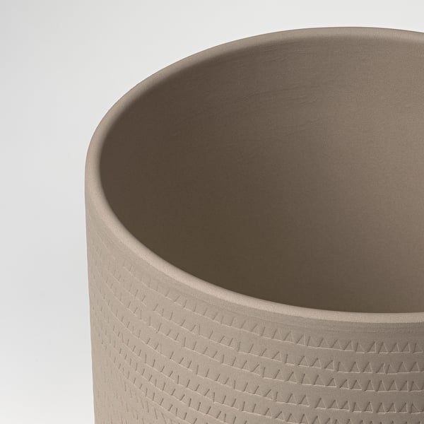 Cylindrical stoneware planter with tactile, triangular pattern. High-quality, smooth finish.