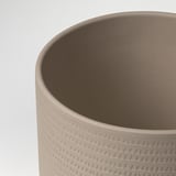 Cylindrical stoneware planter with tactile, triangular pattern. High-quality, smooth finish.