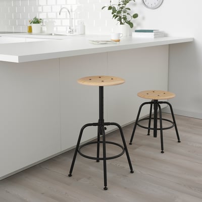 Two KULLABERG stools with black metal bases under kitchen island, adjustable heights.