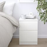 KULLEN nightstand, white with mug, books, clock, green plant.