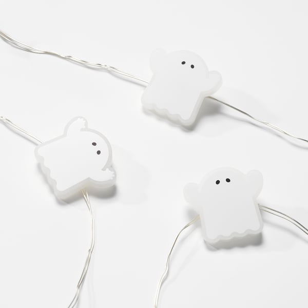 Three glowing ghost-shaped lights on thin, tangled wires against a bright white background.
