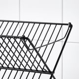 Black metal wire dish drainer close-up, showing sturdy, spaced grid pattern and angled feet for stability.