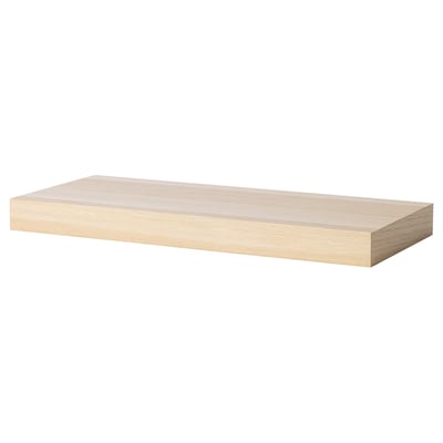 A light-colored wooden wall shelf, simple and rectangular, designed to mount seamlessly on walls.