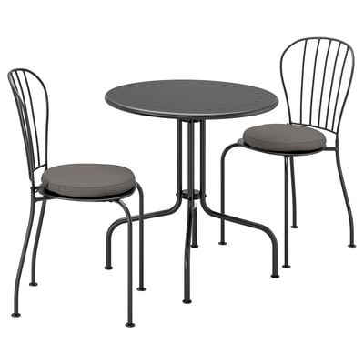 Black outdoor furniture set featuring round table and two stacked chairs with circular cushions and metal frames. Modern, minimalist design.