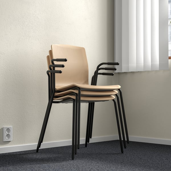 Three stacked LÄKTARE chairs, light birch veneer with black metal legs, shown against a wall.