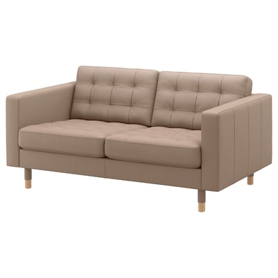 Light brown leather 2-seater sofa, tufted back and seat, wooden legs.