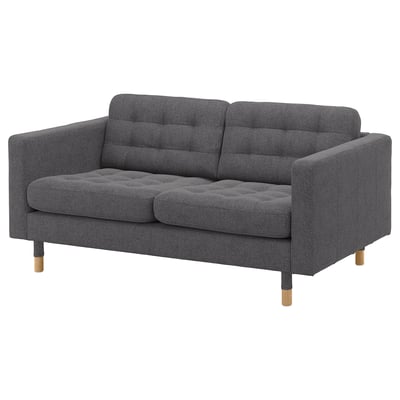 Modern dark gray fabric sofa, tufted seats, wooden legs.