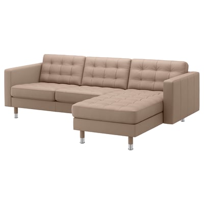 Modern beige l-shaped couch with tufted leather and chrome legs.