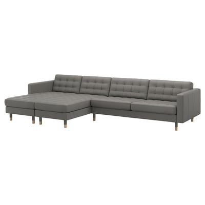 A modern grey l-shaped sofa, LANDSKRONA, with tufted design, sturdy wooden legs, and a mix of leather and fabric.