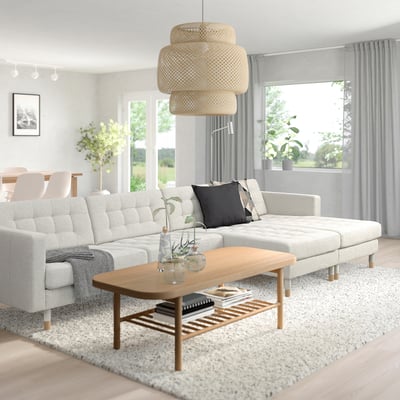 Minimalist living room with LANDSKRONA sofa, coffee table, and pendant lamp, brightened by large windows with curtains.