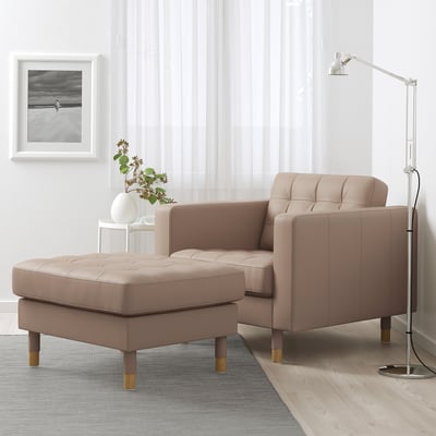Brown LANDSKRONA armchair & ottoman in cosy living room with lamp & vase.