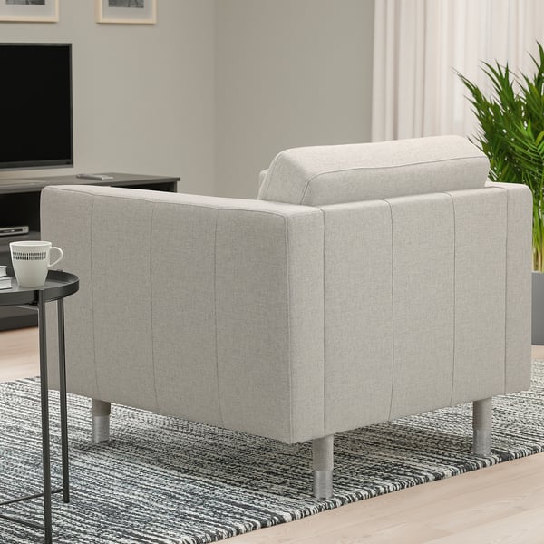 Grey LANDSKRONA armchair with metal legs in modern living room, near side table with mug, tv, and plant.