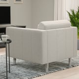 Grey LANDSKRONA armchair with metal legs in modern living room, near side table with mug, tv, and plant.