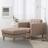 Modern living area with mid-century sofa, lamp, and rug.