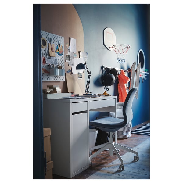 Home office with LÅNGFJÄLL chair, desk, lamp, computer & pegboard.