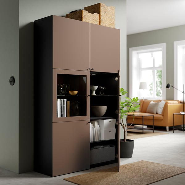 Modern cabinet with glass doors, storing various items, adding a calm vibe.