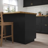 LERHYTTAN black kitchen island. Wooden top, dark base, medium-sized compared to cabinets, modern design.