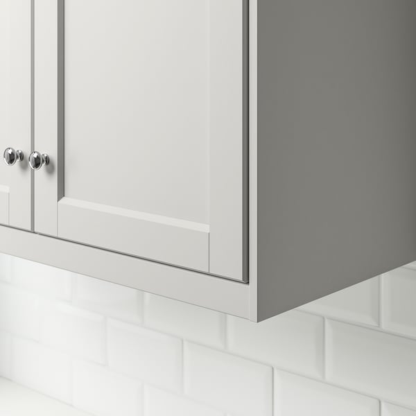 Kitchen cabinet detail with light grey door and chrome handle.