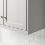 Kitchen cabinet detail with light grey door and chrome handle.