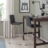 Grey LILLÅNÄS bar stools with padded seats at high table with laptops, coffee, and plant.